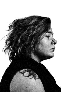 A black and white image of a woman facing right.