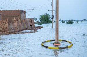VOLTIDE floodwater electrical hazard warning system deployed around a utility pole in a flooded street.