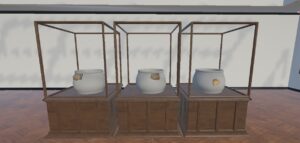 VR museum scene showing three prehistoric pottery fragments displayed on low-detail vessel references in separate cases.