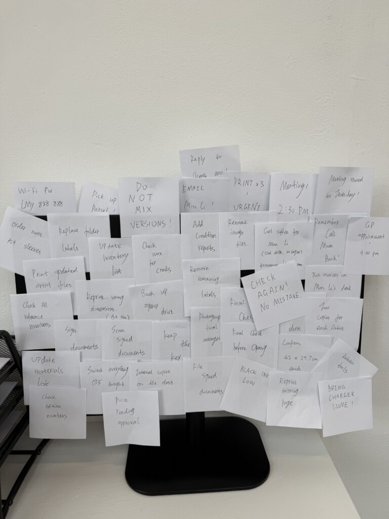 Handwritten office notes covering a monitor in the LMy Artist Agency installation