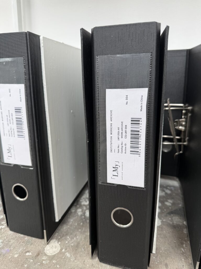 Black archive folders with LMy Artist Agency inventory labels and barcodes.