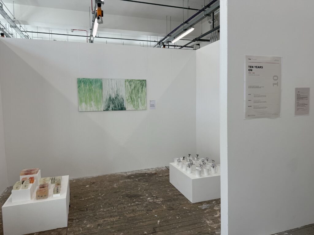 Exhibition view of LMy Artist Agency showing three installations in a white gallery space.